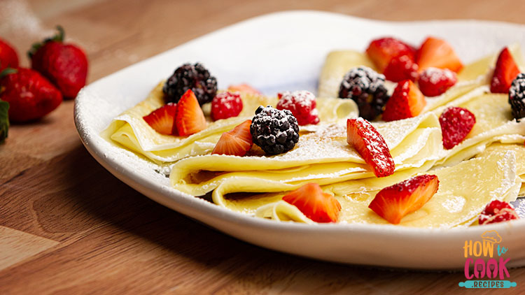 crepes and berries with powdered sugar
